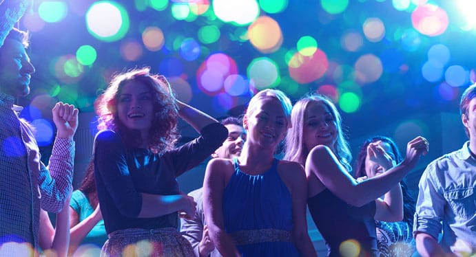party, holidays, celebration, nightlife and people concept - group of happy friends dancing in night club