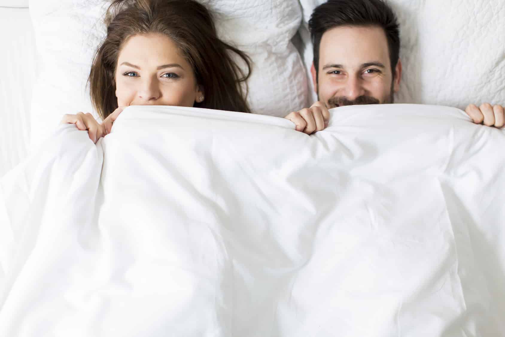 Young loving couple in the bed